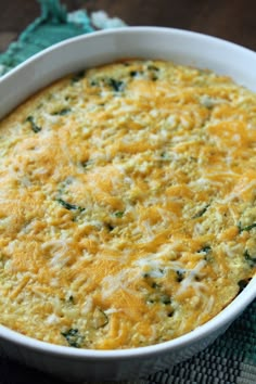 a casserole with cheese and spinach in a white dish on a table