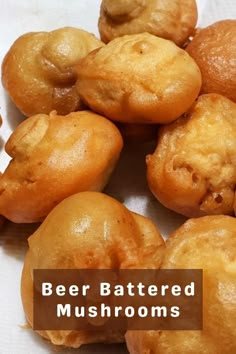 a bunch of food that is sitting on a paper towel with the words beer battered mushrooms