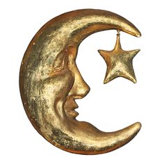 a gold moon and star hanging on a white background