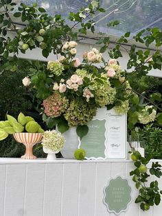 there are many flowers in the vases on the ledge above the planter box