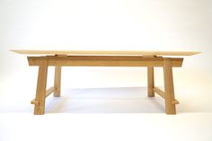 a wooden bench sitting on top of a white floor