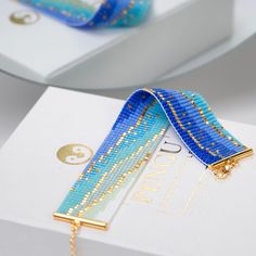 a blue and gold ribbon on a white box