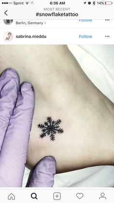 a snowflake tattoo on the side of a woman's left foot is shown