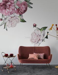 a living room with flowers painted on the wall and a couch in front of it