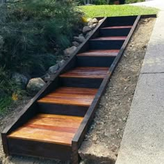 a set of steps made out of wood and metal on the side of a road