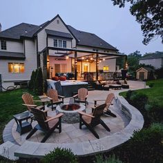 an outdoor patio with chairs and fire pit