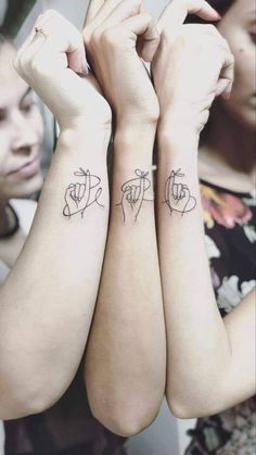 two people with matching tattoos on their arms