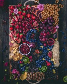 an assortment of fruits and pastries laid out on a board