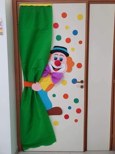 the door is decorated with colorful polka dots and a clown puppet hanging from it's side