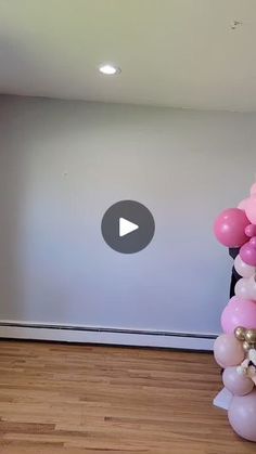 a room filled with balloons and a white wall