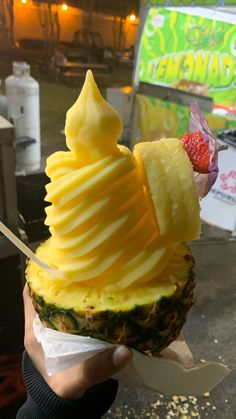 a pineapple ice cream sundae topped with fruit