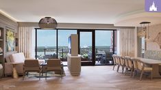 a living room filled with furniture and a large window covered in curtains next to a balcony