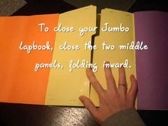 someone's hand on top of an open book with the words to close your jumbo lapbook, close the two middle panels, folding inward