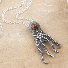 The ocean is home to fascinating creatures that surprise people every day. One of those unique aquatic beings is the octopus, a marine cephalopod famous for its incredible intelligence, which inspires artisan Bhavya Jain to create this stunning accessory from sterling silver. Polished for a dazzling look, this octopus pendant necklace also comes with a natural garnet stone, crowning the design with its intense crimson tone. Octopus Pendant, India Gift, The Octopus, Garnet Pendant, Funky Jewelry, Garnet Stone, Rolo Chain, Jewelry Packaging, Jewelry Gift Box