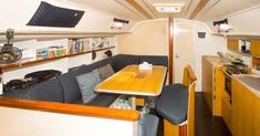 the kitchen and dining area in an rv with wood flooring, white walls and ceiling