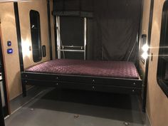 the inside of an rv with a bed in it