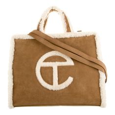 Ugg X Telfar Tote Brown Suede Graphic Print Silver-Tone Hardware Flat Handles & Single Shoulder Strap Twill Lining & Single Interior Pocket Snap Closure At Top Shoulder Strap Drop: 21" Handle Drop: 4.5" Height: 14.75" Width: 19.25" Depth: 7" Ugg Purses, Telfar Bags, Messenger Bag Backpack, Saint Laurent Bag, Waist Bags, Work Bags, Backpack Travel Bag, Bag Handle, Vuitton Bag