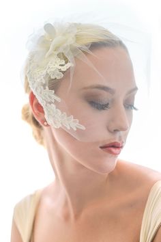 a woman wearing a veil with flowers on it