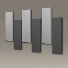 a set of five square and rectangle metal wall art pieces on a gray background