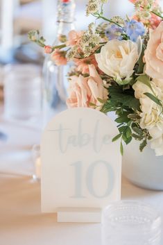 a table number with flowers in a vase