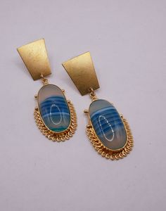 Blue striped agate stone with gold wire on gold plated earrings. 2 1/2 inches Before making a purchase, please reach out to us with any inquiries via Etsy messages. If you find yourself dissatisfied, kindly initiate a discussion about an exchange or return within 7 days of receiving the item. Returns will be accepted within 7 days, with shipping costs deducted. Unfortunately, international returns are not accepted. For returns, a restocking fee of $15.00 per item is applicable. Exchanges are handled on a case-by-case basis, and if agreed upon, the buyer is responsible for additional shipping charges. Items must be returned in their original condition; otherwise, refunds and exchanges cannot be processed. Agate Earrings, Blue Agate, Gold Wire, Gold Plated Earrings, Agate Stone, Jewelry Earrings Dangle, Etsy Earrings, Dangle Drop Earrings, Agate