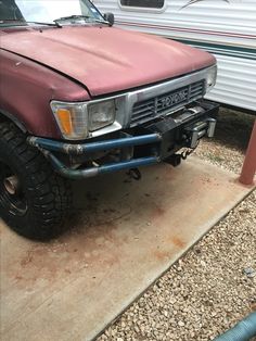 a red truck parked next to a trailer