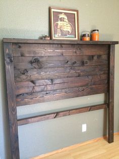 the headboard is made out of wood and has an old fashioned design on it