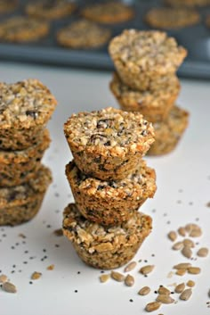 several muffins stacked on top of each other with oats scattered around them