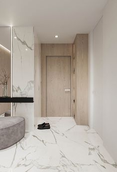 a bathroom with marble flooring and large mirror on the wall next to it's sink