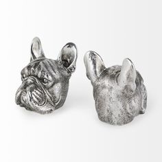 two silver bulldog heads sitting next to each other