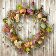 an easter wreath with flowers and eggs