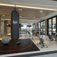 a gym with exercise equipment and large windows