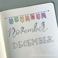 an open notebook with the words november and december written in cursive writing on it