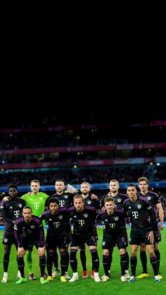 the soccer team is posing for a group photo on the field in front of an empty stadium