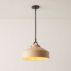 a light fixture hanging from the ceiling in a room with white walls and flooring