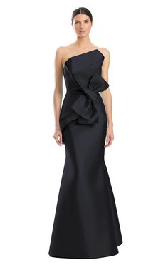 a woman wearing a black gown with a large bow on the back and one shoulder