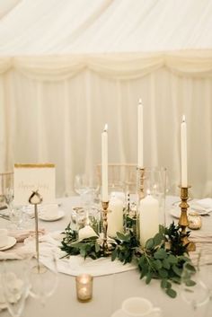 the table is set with candles and place settings