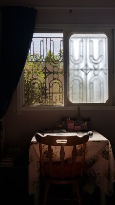 a table and chair in front of a window