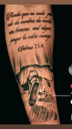 a man with a tattoo on his arm that has a bible verse written in it