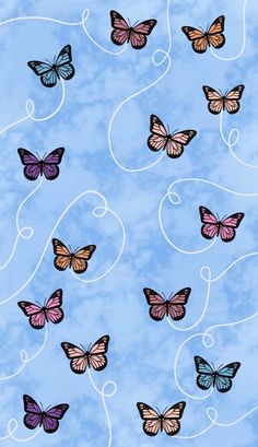 several butterflies flying in the sky with swirls on it's back ground and blue background