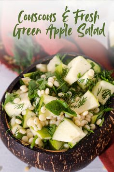 a wooden bowl filled with cucumbers and fresh green apple salad