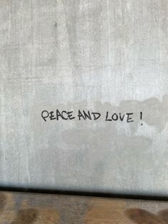 graffiti on the side of a wall that says peace and love written in black ink