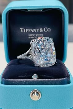 a diamond ring in a blue box with the words tiffany & co written on it