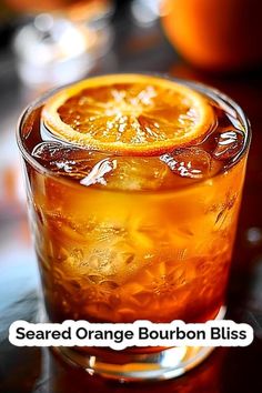 an orange is sitting in a glass with ice