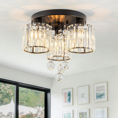 a chandelier hanging from the ceiling in a living room