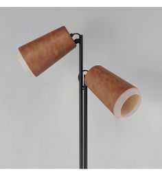 two brown lamps are sitting on a black stand next to each other and one light is turned off