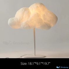 a white cloud lamp sitting on top of a table