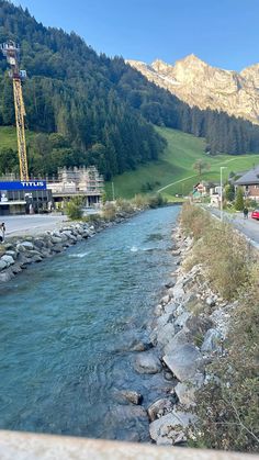 a river running through a lush green hillside