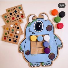 a wooden board game with an image of a monster on it next to some buttons