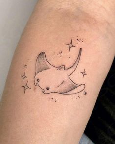 a tattoo on the arm of a woman with stars and an animal's head